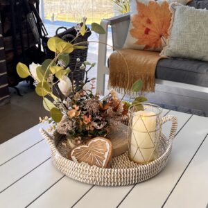 Floral arrangement and candle in a tray vignette